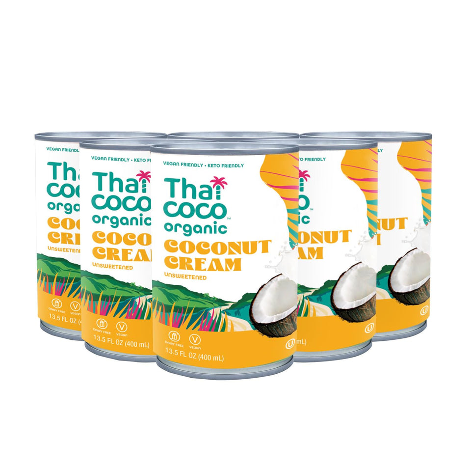 Thai Coco coconut cream being poured over curry for rich texture.