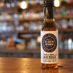 The Cocktail Experiment Lavender Bitters botanicals display with lavender and juniper.