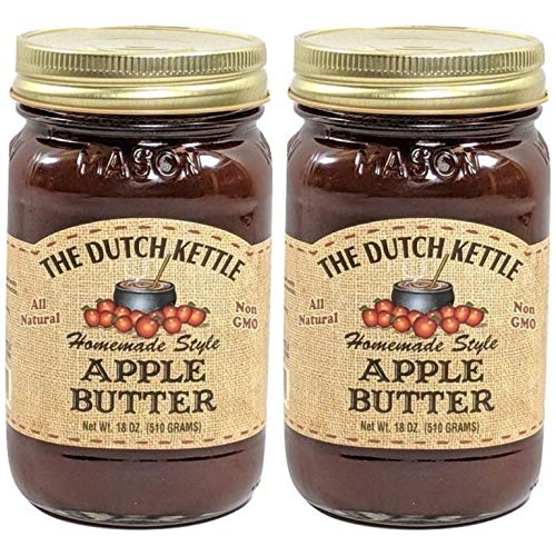 The Dutch Kettle Apple Butter jar on a rustic kitchen countertop, perfect for toast.