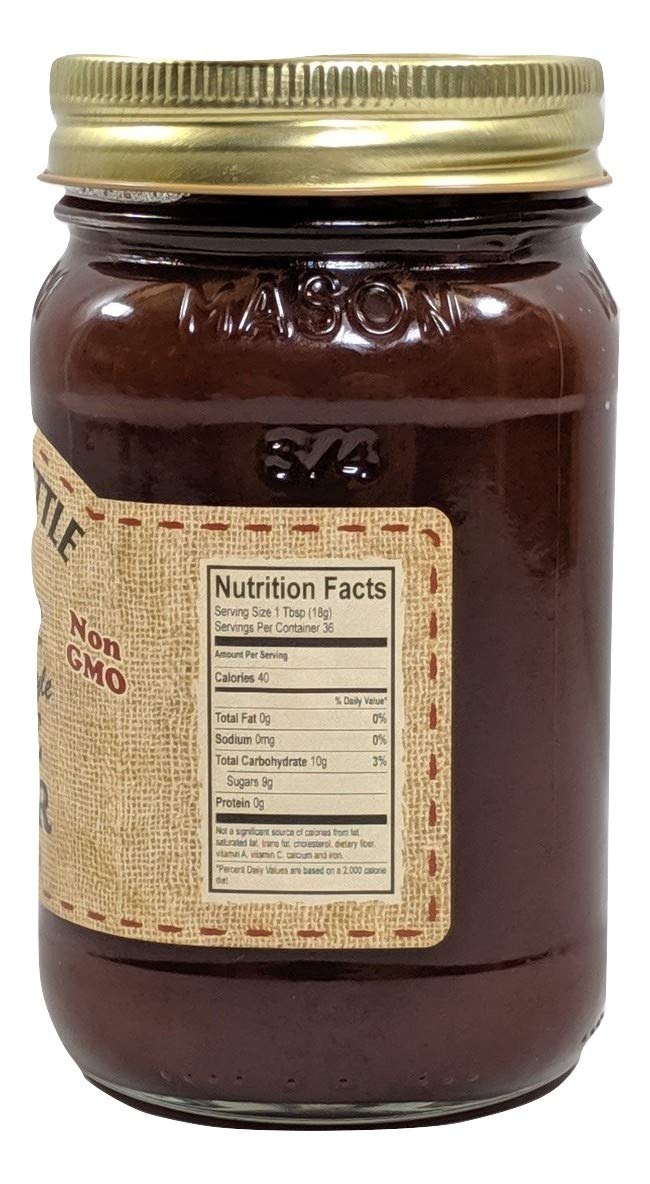 The Dutch Kettle Apple Butter jar with a wooden spoon, ideal for baking glaze.