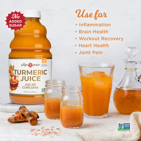 The Ginger People turmeric juice in a glass with ice, ready to mix into smoothies.