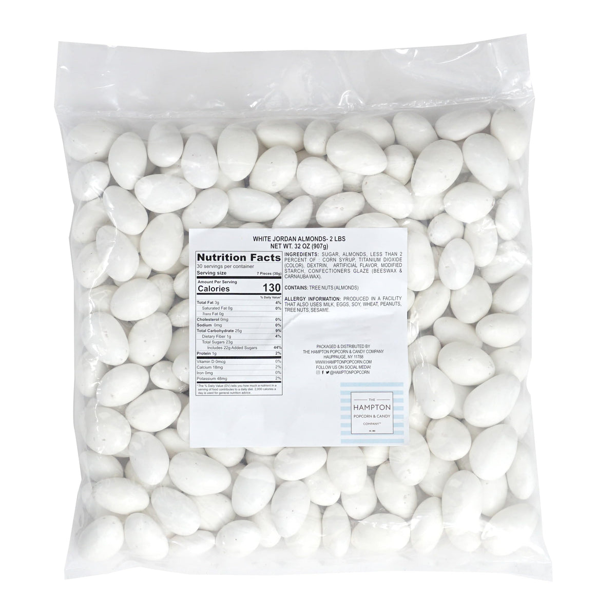 White Jordan Almonds in a glass bowl for elegant wedding candy accents.