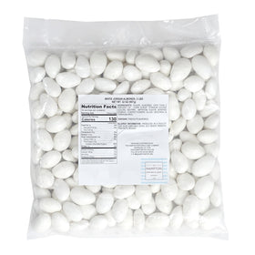 White Jordan Almonds in a glass bowl for elegant wedding candy accents.