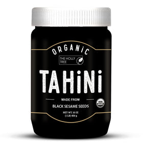 The Holly Tree Black Tahini Paste jar showing rich color and creamy texture.