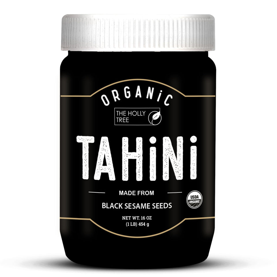 The Holly Tree Black Tahini Paste jar showing rich color and creamy texture.