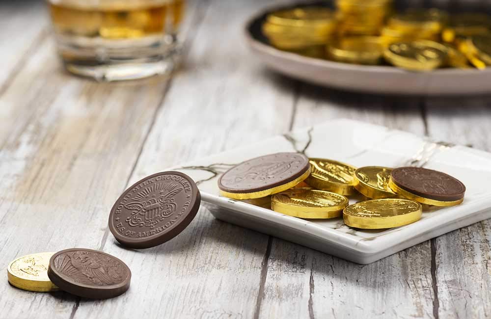 Close-up of individually wrapped gold foil wrappers preserving freshness for party favors.