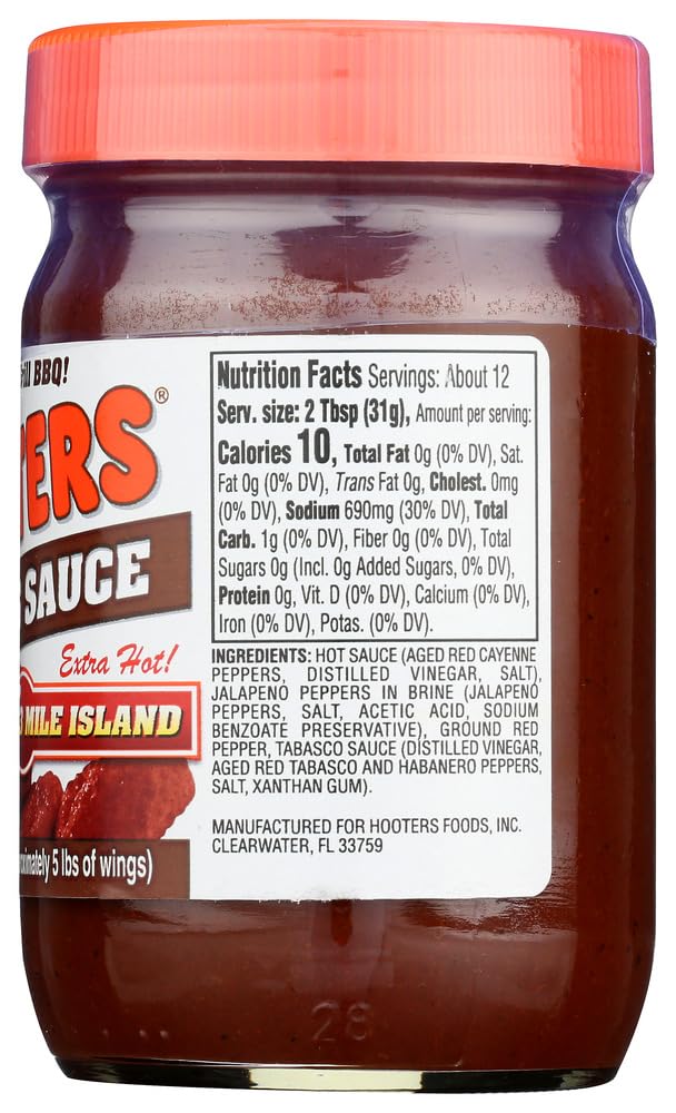 The Original Hooters Wing Sauce on table with wings ready to dip