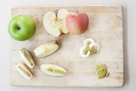 Stirring pistachio butter to restore creaminess for desserts or smoothies