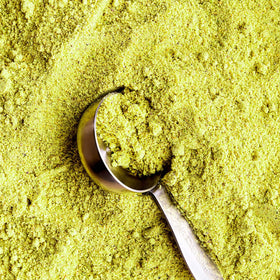 The Pistachio Factory pistachio flour being sifted over batter for versatile baking