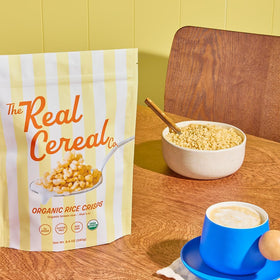 The Real Cereal Company non-GMO certification label on cereal box.