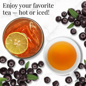 A glass of The Republic of Tea Acai Berry Green Tea shows deep purple hues.
