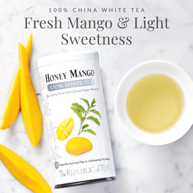Cup with steeped Honey Mango White Tea highlighting bright aroma.