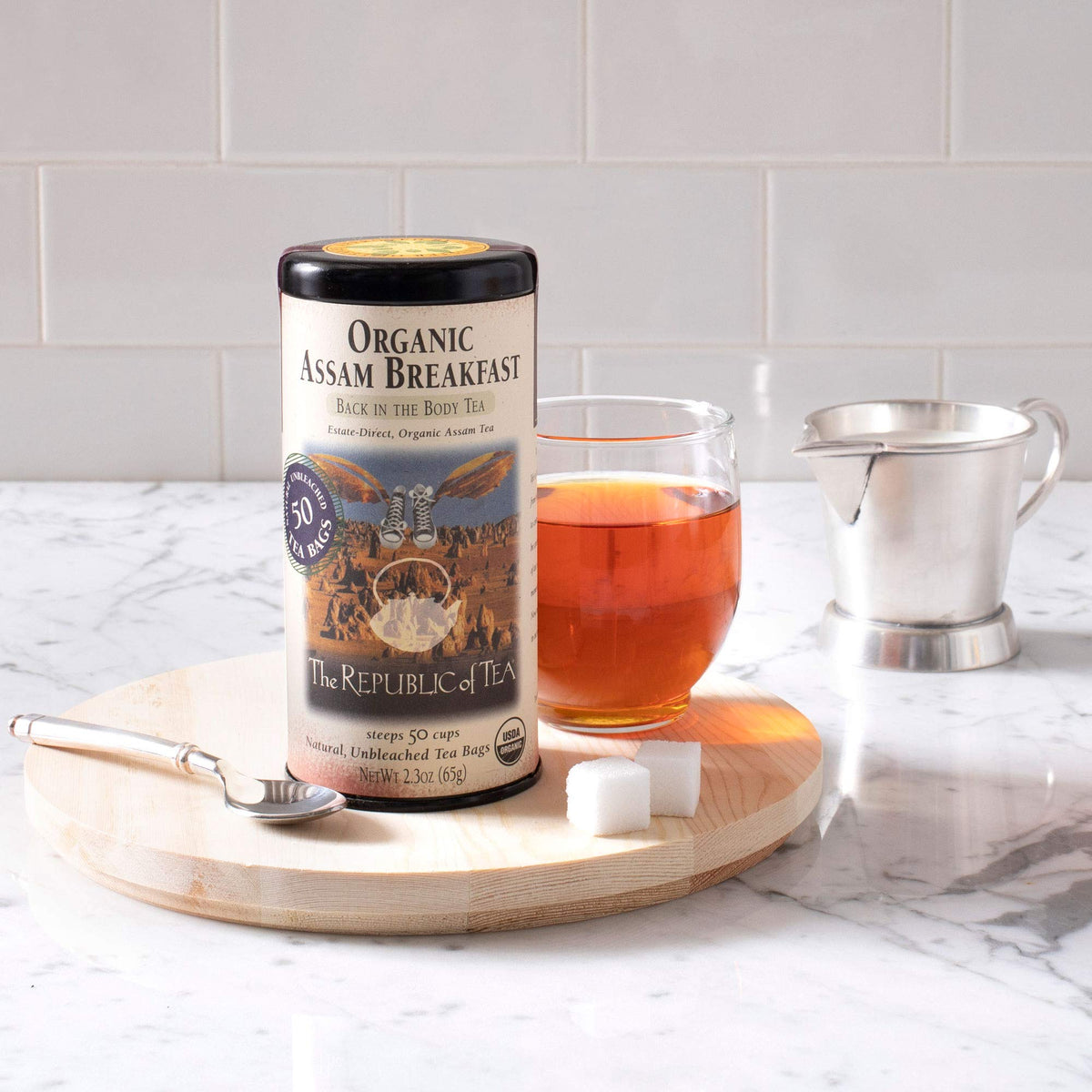 The Republic of Tea organic black tea tin on a kitchen counter for daily tea enjoyment.