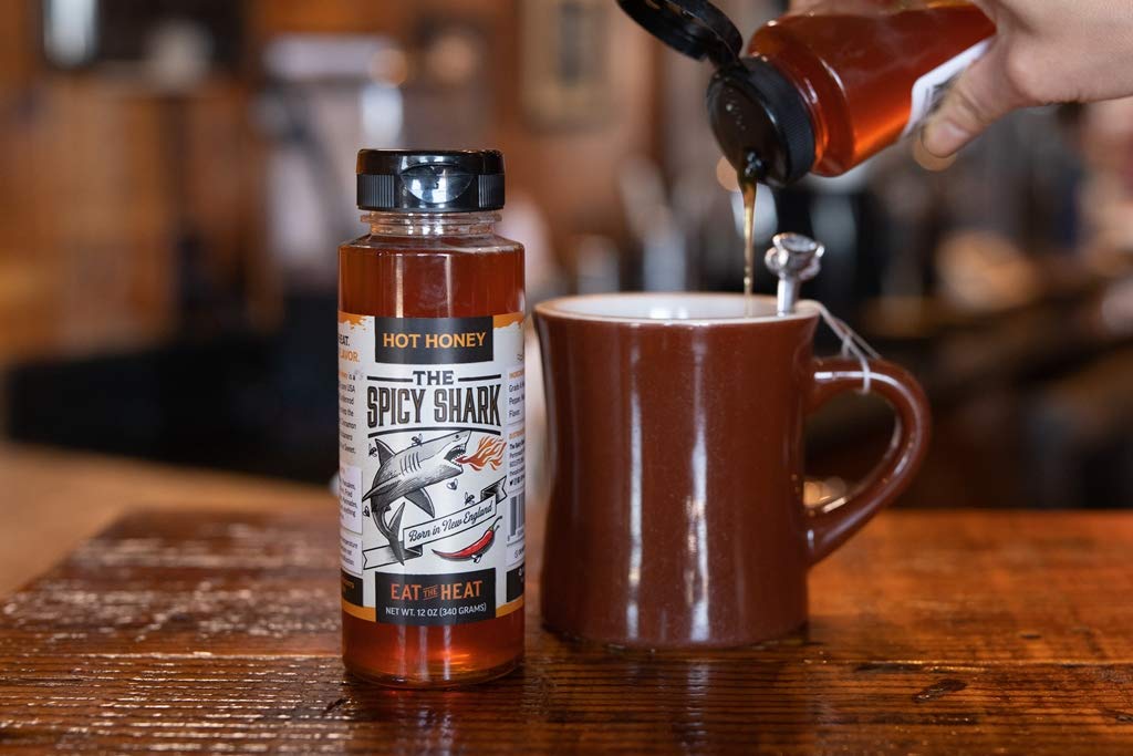 The Spicy Shark Hot Honey on a warm biscuit highlighting sweet-spice pairing.