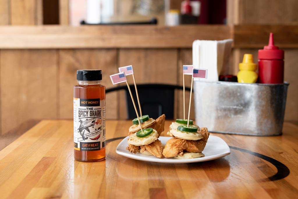 The Spicy Shark Hot Honey over pancakes suggests breakfast drizzle with a kick.