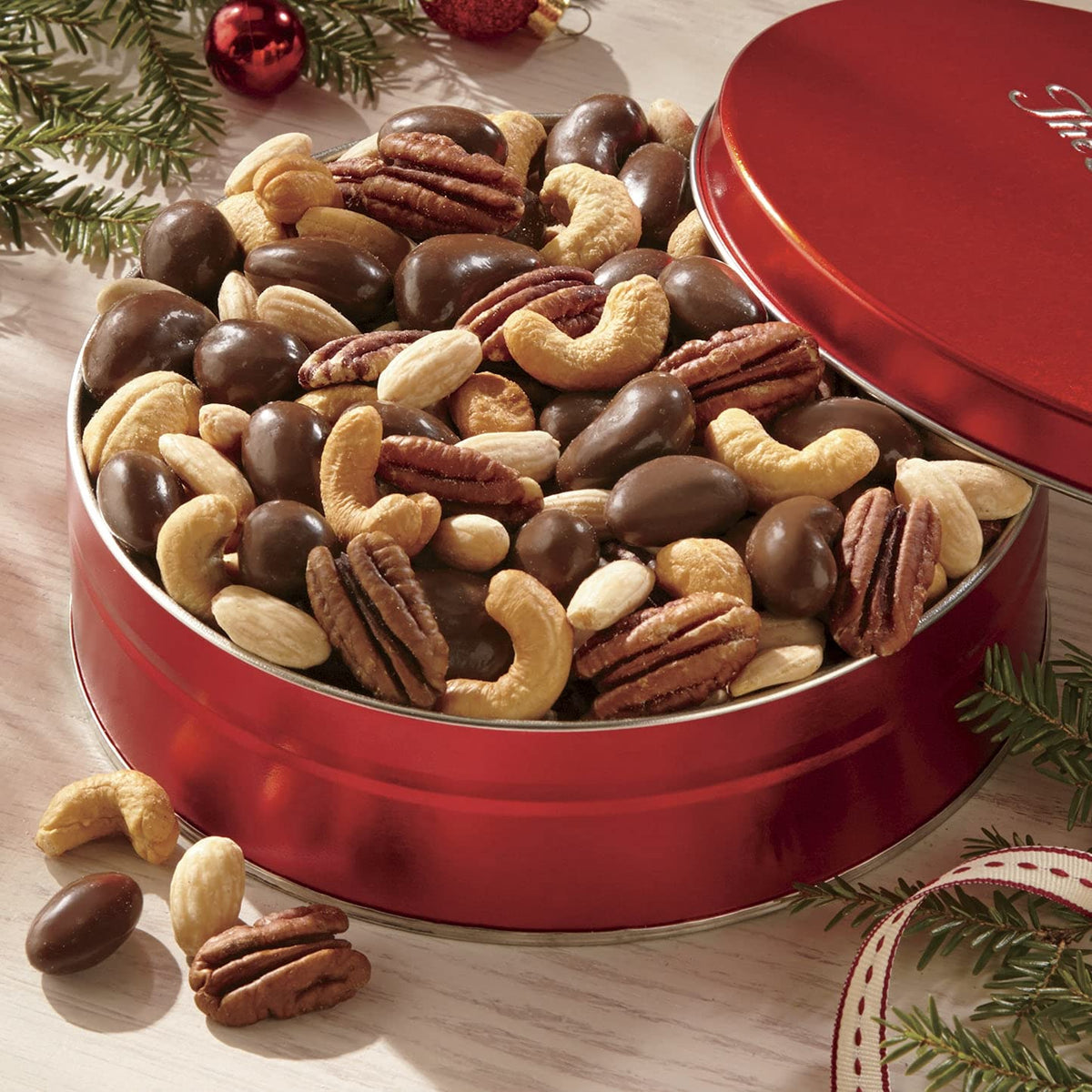 The Swiss Colony Premium Nut Assortment chocolate-covered cashews offer sweet, creamy indulgence.