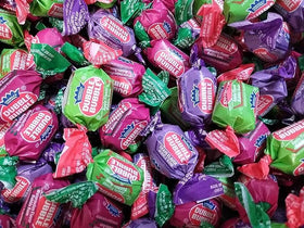 TheCandyCo Dubble Bubble bulk display with watermelon, grape, and apple flavors.