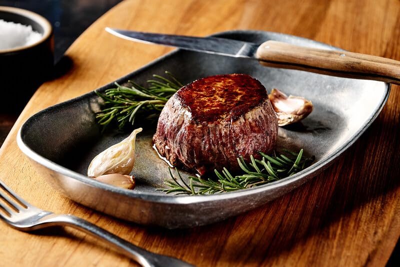 The Rancher's Butcher premium steak box NY strip highlighting bold flavor for pan-searing.