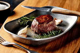 The Rancher's Butcher premium steak box NY strip highlighting bold flavor for pan-searing.