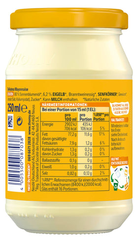 Thomy mayonnaise bottle pouring onto a sandwich for creamy flavor