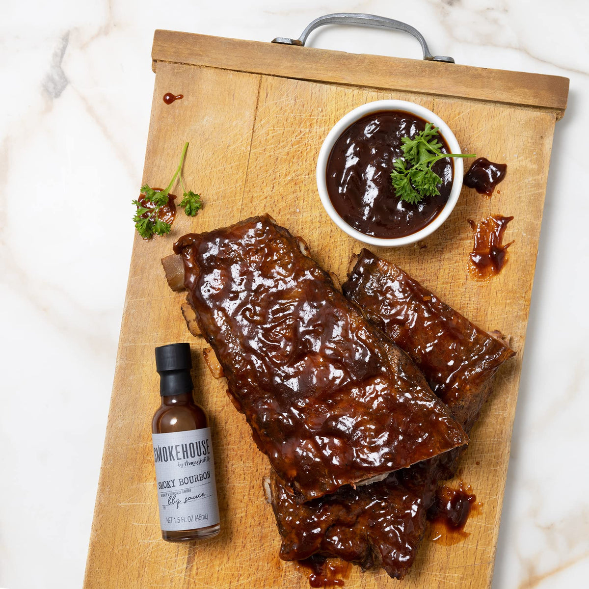 Thoughtfully Smokehouse Sweet and Spicy sauce pairs with wings and veggies.