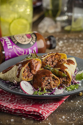 Red jalapeño imagery in TIA LUPITA sauce signaling authentic heat from peppers.