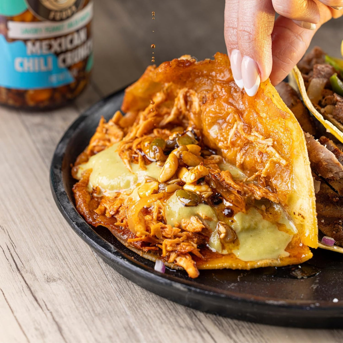 TIA LUPITA dipping taco shot suggesting versatile finishing drizzle