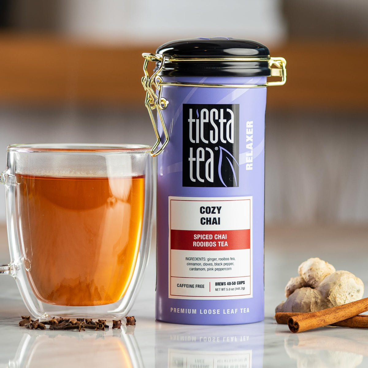 Tiesta Tea loose-leaf Cozy Chai Rooibos being scooped for brewing.