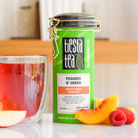 Tiesta Tea Peaches N' Green tea leaves close-up, premium loose leaf quality.