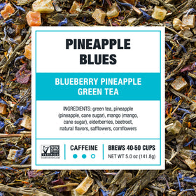 Pineapple Blues brew in a glass with steam ready to enjoy hot or iced