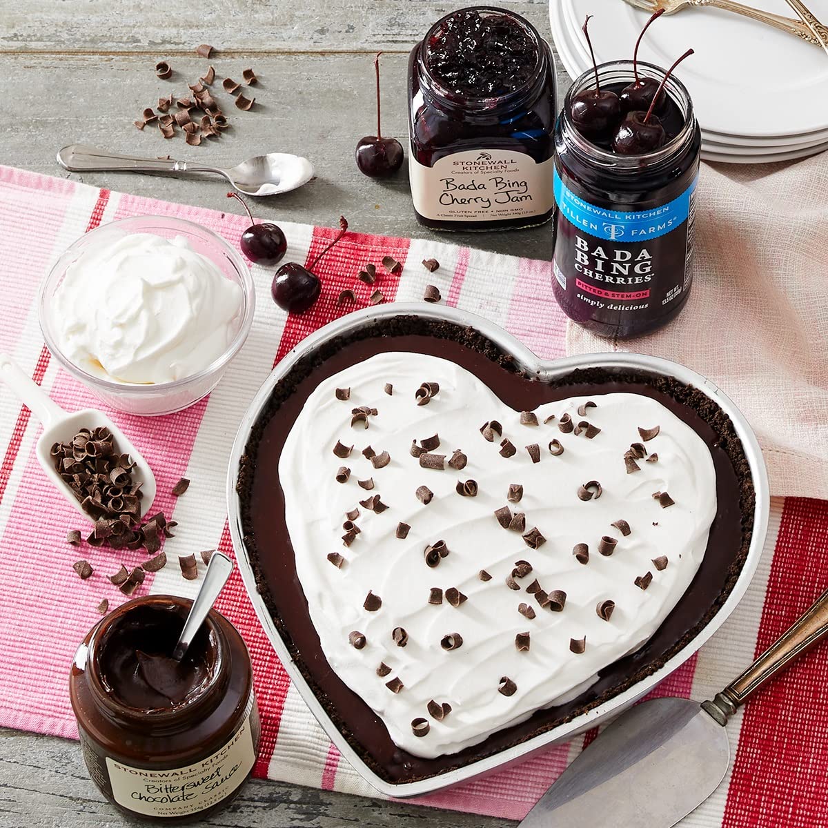 Spoon lifting bourbon Bada Bing cherries from a jar for tasting.