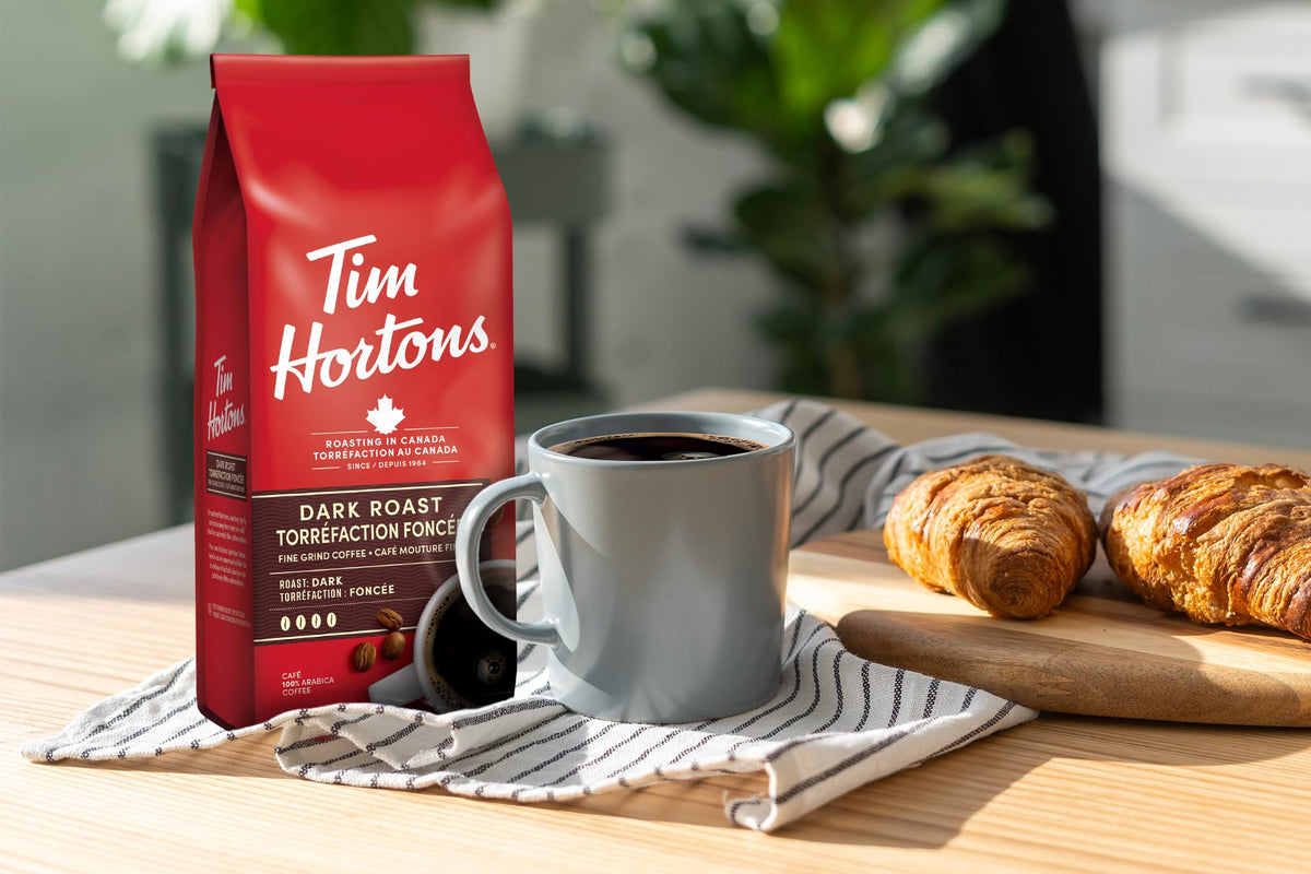 Tim Hortons dark roast cup with sip, pairs well with cream for smooth flavor.