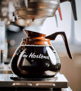 Tim Hortons decaf ground coffee beans close-up, rich aroma ready to brew.