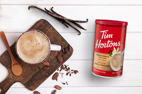 Tim Hortons Instant Cappuccino French Vanilla being stirred with hot water to reveal creamy vanilla