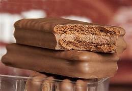 Tim Tam served on a tea-time plate, suggesting perfect tea pairing.