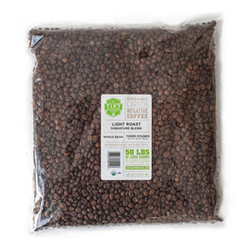 Tiny Footprint Coffee Signature Blend Light Roast packshot showcases organic, shade-grown beans for a bright morning brew.
