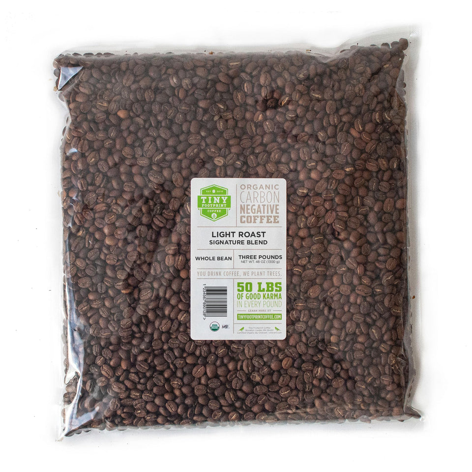 Tiny Footprint Coffee Signature Blend Light Roast packshot showcases organic, shade-grown beans for a bright morning brew.