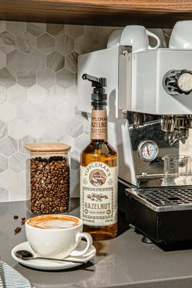 Coffee scene with Tippleman's Hazelnut Syrup for cafe-style drinks at home.