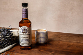 Tippleman's Lavender Syrup beside an iced beverage showcasing versatility.