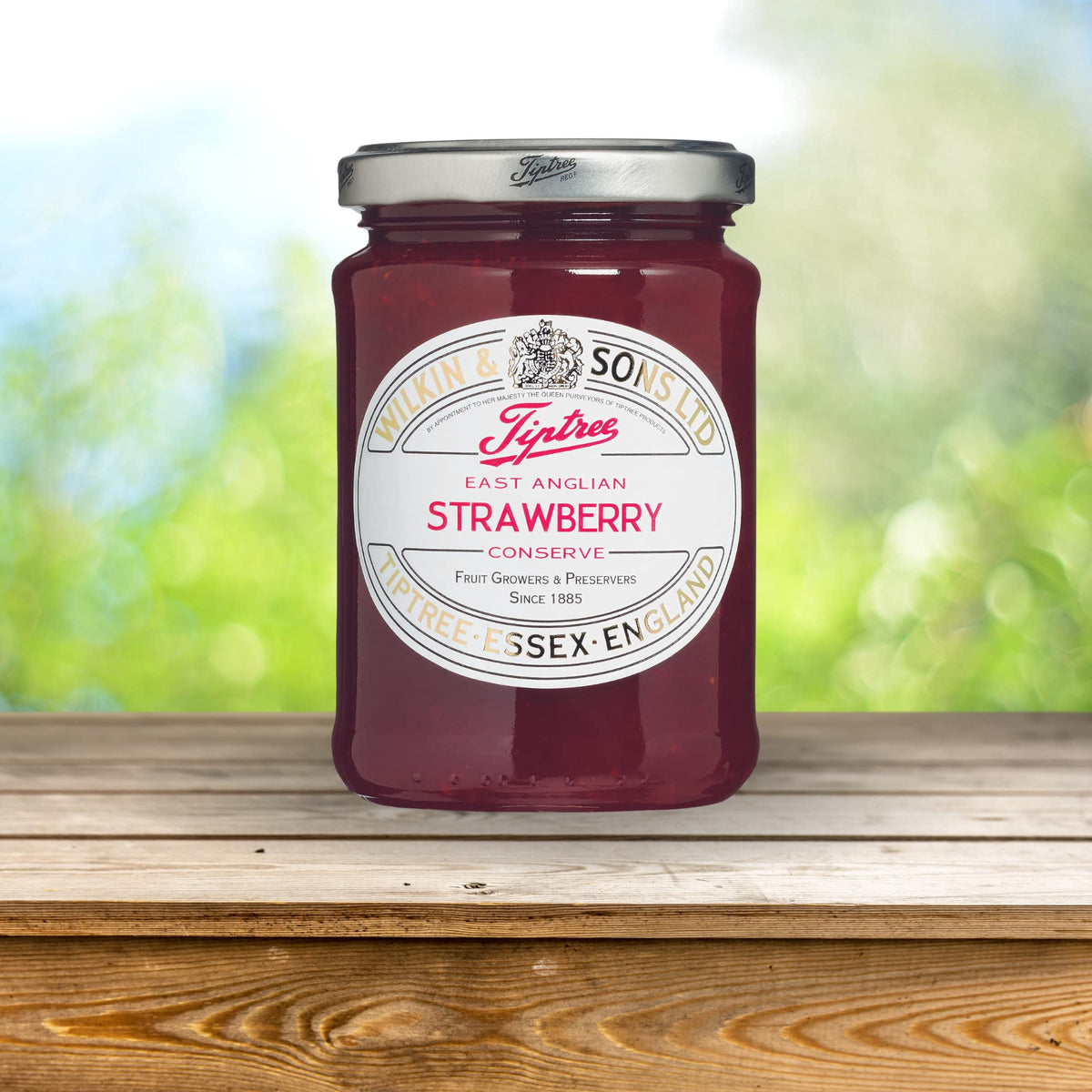Tiptree conserve being poured, showing glossy texture and inviting sweetness.