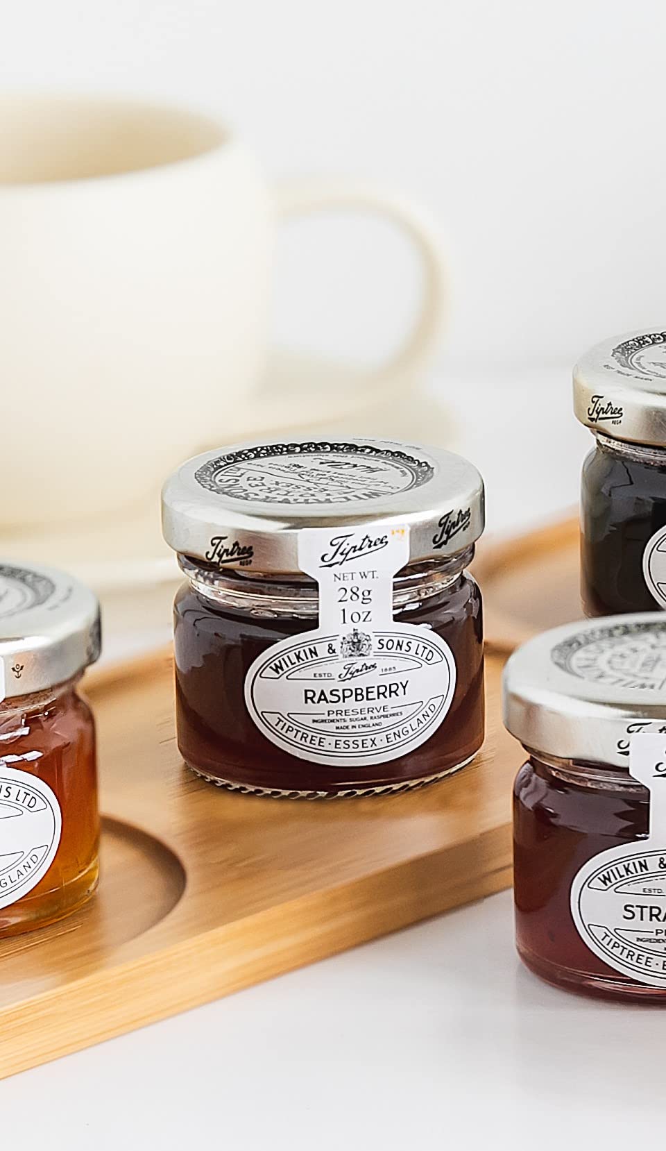 Tiptree Raspberry Preserve Minis being poured, highlighting spreadable texture