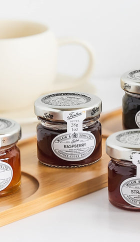 Tiptree Raspberry Preserve Minis being poured, highlighting spreadable texture