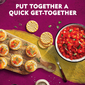 Toasteds crackers paired with meats on a charcuterie plate for entertaining
