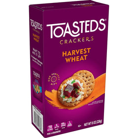 Toasteds Harvest Wheat crackers beside a cheese and hummus spread.