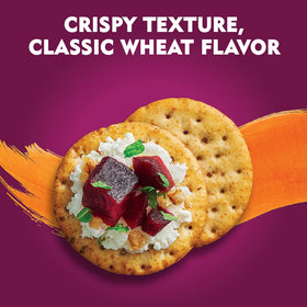 Toasteds Harvest Wheat crackers on a party board with dips.