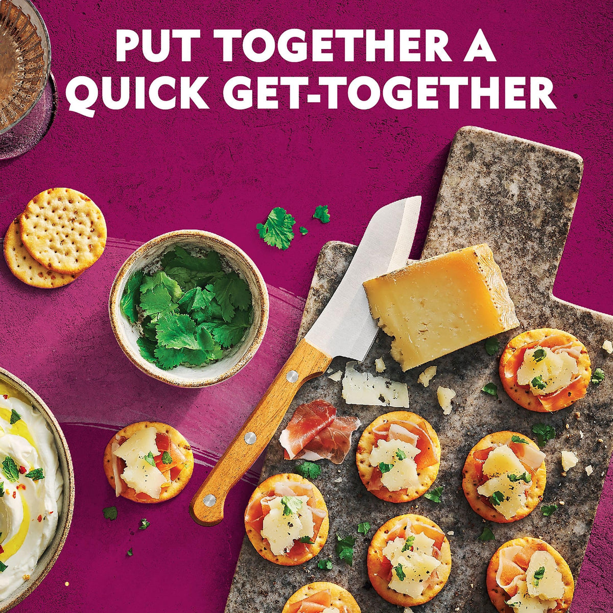 Toasteds Savory Onion crackers with hummus for dip-ready snacking.