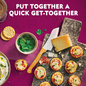 Toasteds Savory Onion crackers with hummus for dip-ready snacking.