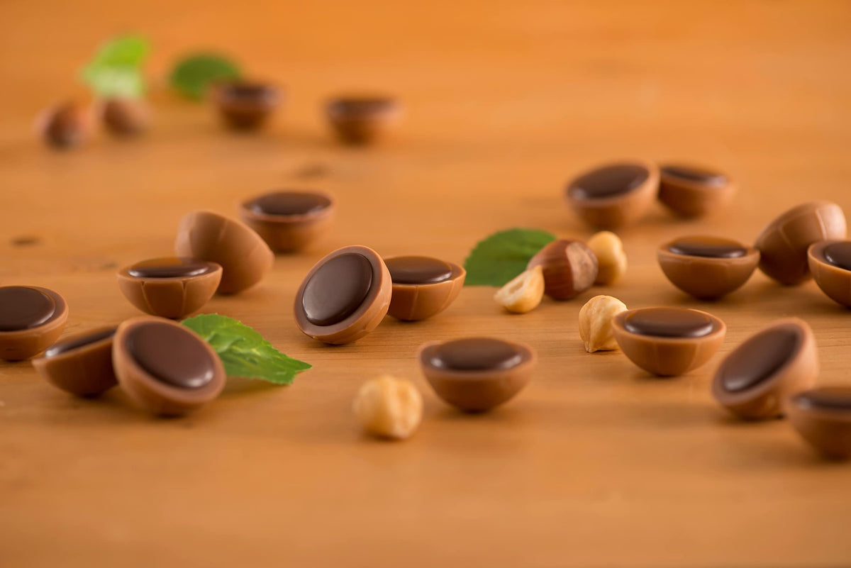 Close-up of Toffifee chocolate cup with glossy outer shell.