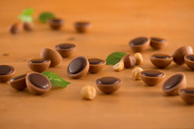 Close-up of Toffifee chocolate cup with glossy outer shell.