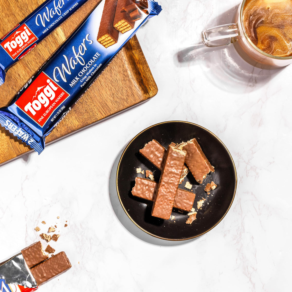 Toggi milk chocolate wafers coffee-break image, pair with hot beverage for a moment of indulgence.